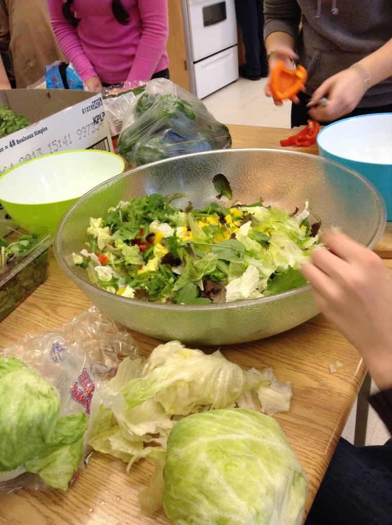 Team members making salad